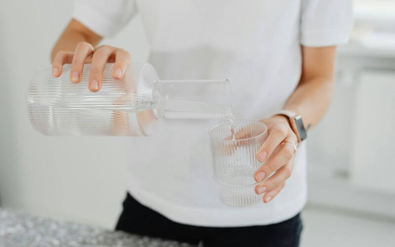 woman making bed neatly in morning creating sense of completion and achievement