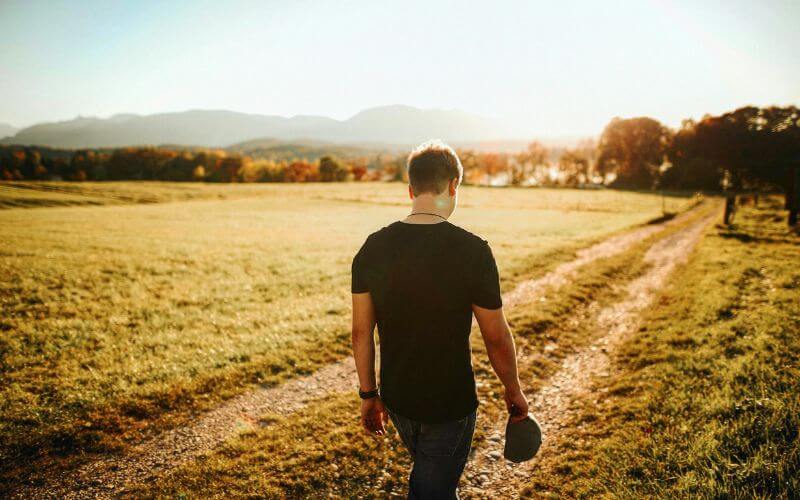 person walking in morning sunlight healthy daily habits personal growth