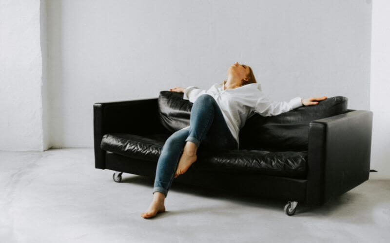 woman lazy sitting thinking how to overcome laziness