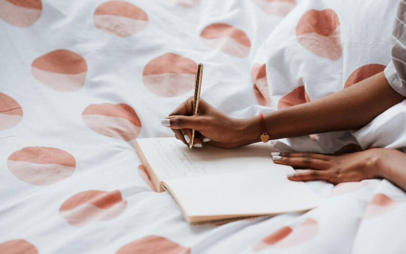how to stop being lazy woman writing morning goals clarity