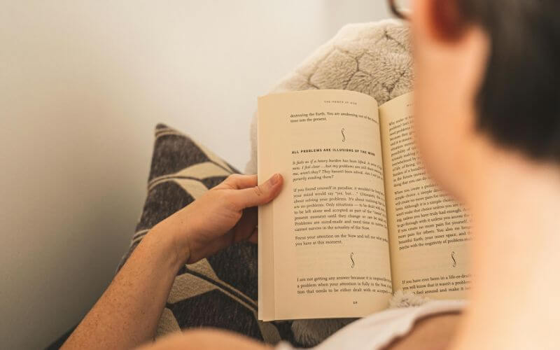 Woman journaling in morning light practicing daily personal growth tips for a better life