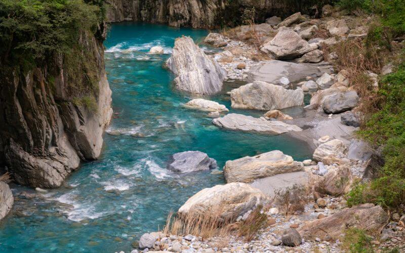 power of consistency like a river flowing steadily through rocks in nature