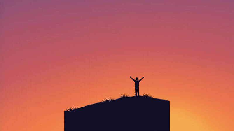 person standing with open arms feeling free after accepting yourself and moving forward